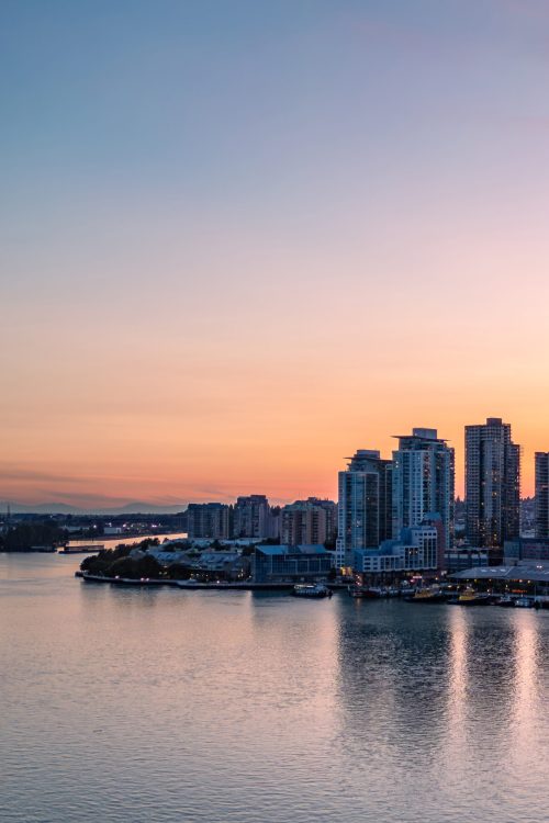 Aerial View of City Buildings by river at twilight. New Westmister, Vancouver, BC, Canada.